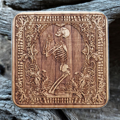 Hand-painted wireless charger with dark Pray artwork on wood.