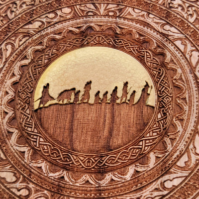 Artisan wireless charger with Tolkien-inspired fellowship design.