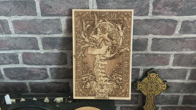 Macabre skull and spine wood art, an eerie gothic decor piece for horror lovers.