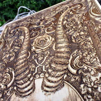 Hand-engraved horned skull on wood – gothic and macabre art piece for alternative decor lovers.