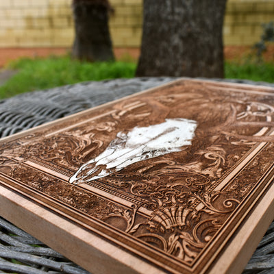 Rustic cedar wall art featuring a laser-etched deer skull design, handmade decor.