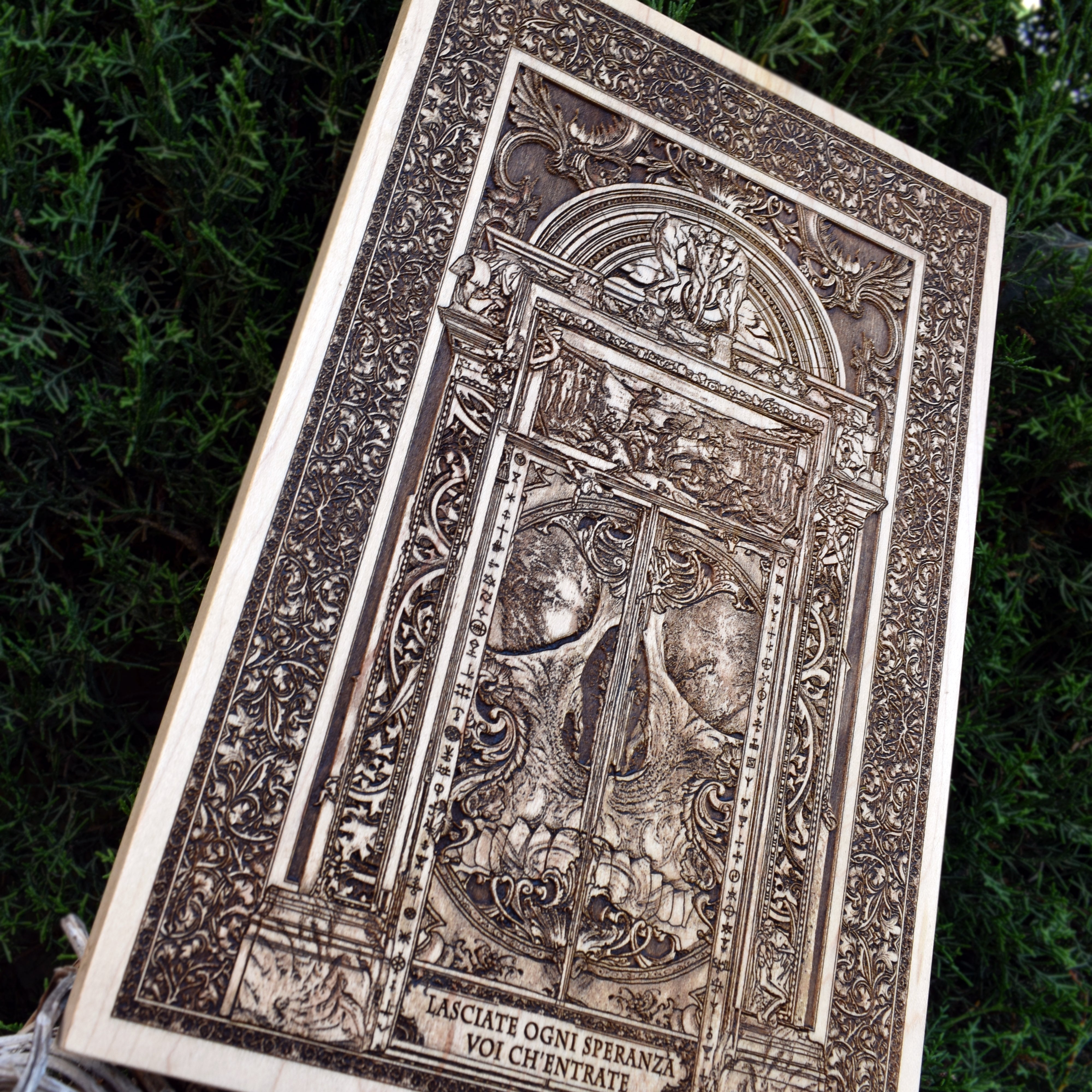 Handcrafted Hell Gate artwork with demonic gate design, engraved on wood.