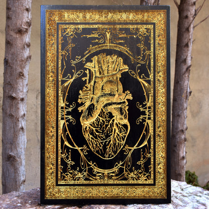 Black anatomical heart wood wall art, engraved for gothic or romantic decor.