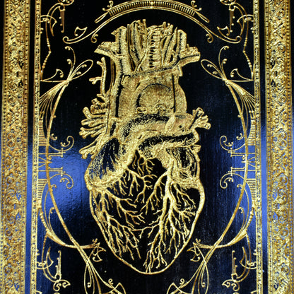 Engraved anatomical black heart wall plaque, emotional love-themed art.