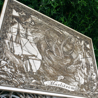 Nautical wood art with intricate laser engraving of a stormy sea and shipwreck.