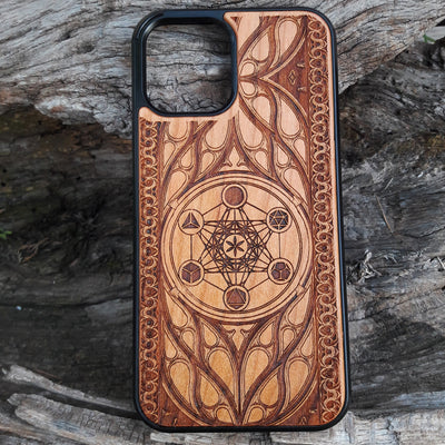 Wooden phone case featuring a laser-engraved Metatron's Cube design, intricately detailed with geometric patterns and mystical symbols. While the design itself is not specifically Lord of the Rings, its gothic and esoteric style creates a captivating, symbolic representation. Compatible with iPhone , 15, 14, 13, 12, 11 Pro Max Mini, and Samsung Galaxy S, S24, S23, S22, S21, S20 Ultra, Plus, and Note 20. A unique and protective accessory for those who appreciate geometric designs and spiritual symbolism.