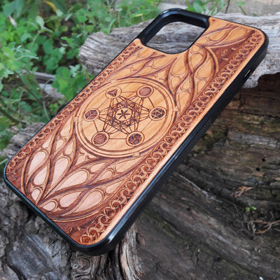 Wooden phone case featuring a laser-engraved Metatron's Cube design, intricately detailed with geometric patterns and mystical symbols. While the design itself is not specifically Lord of the Rings, its gothic and esoteric style creates a captivating, symbolic representation. Compatible with iPhone , 15, 14, 13, 12, 11 Pro Max Mini, and Samsung Galaxy S, S24, S23, S22, S21, S20 Ultra, Plus, and Note 20. A unique and protective accessory for those who appreciate geometric designs and spiritual symbolism.