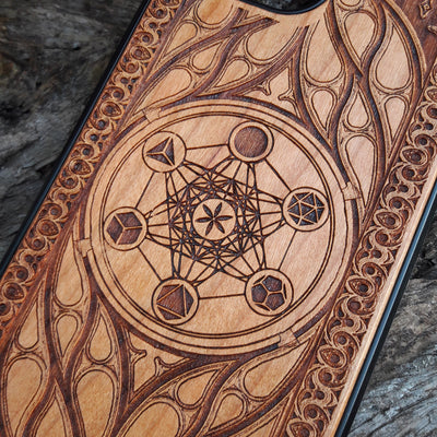 Wooden phone case featuring a laser-engraved Metatron's Cube design, intricately detailed with geometric patterns and mystical symbols. While the design itself is not specifically Lord of the Rings, its gothic and esoteric style creates a captivating, symbolic representation. Compatible with iPhone , 15, 14, 13, 12, 11 Pro Max Mini, and Samsung Galaxy S, S24, S23, S22, S21, S20 Ultra, Plus, and Note 20. A unique and protective accessory for those who appreciate geometric designs and spiritual symbolism.