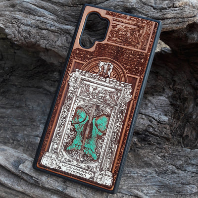 Hand-painted and laser-engraved "Hell Gate II" wooden phone case depicting a demonic skull on cherrywood. Compatible with iPhone -11 Pro Max and Galaxy S-S20 models.