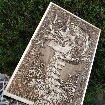 Handcrafted wooden art featuring a terrifying screaming skull and spine, ideal for gothic decor.
