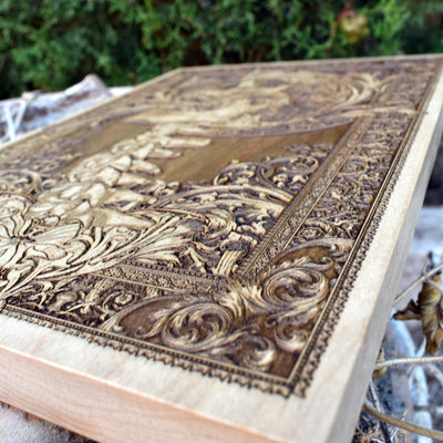 Gothic horror wood wall art featuring a screaming skull with spine, a unique dark aesthetic piece.