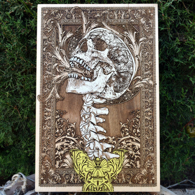 Engraved screaming skull and spine wood art, perfect for gothic horror home decor.