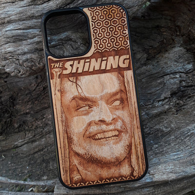 Wooden phone case featuring The Shining-inspired movie character design, intricately engraved, available for iPhone , Galaxy S, and more. Ideal for fans of classic horror films.