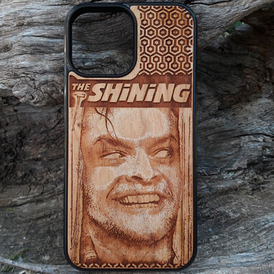 Wooden phone case featuring The Shining-inspired movie character design, intricately engraved, available for iPhone , Galaxy S, and more. Ideal for fans of classic horror films.