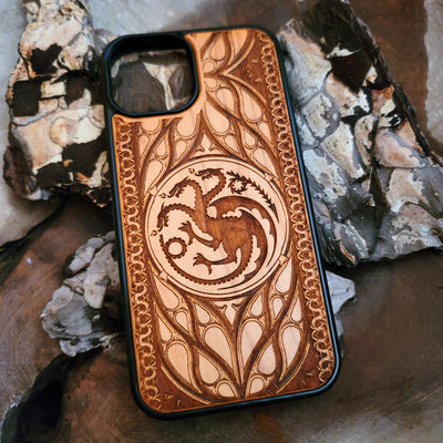 Game of Thrones-inspired wood phone case featuring the Targaryen sigil, laser-engraved with intricate detailing for a unique design. Made from durable wood, this case offers protection and style. Compatible with iPhone , 15, 14, 13, 12, 11, Pro Max, Mini, and Samsung Galaxy S, S24, S23, S22, S21, S20 Ultra, Plus, Note 20. Perfect for fans of Westeros seeking an elegant and protective accessory.