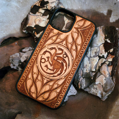 Game of Thrones-inspired wood phone case featuring the Targaryen sigil, laser-engraved with intricate detailing for a unique design. Made from durable wood, this case offers protection and style. Compatible with iPhone , 15, 14, 13, 12, 11, Pro Max, Mini, and Samsung Galaxy S, S24, S23, S22, S21, S20 Ultra, Plus, Note 20. Perfect for fans of Westeros seeking an elegant and protective accessory.