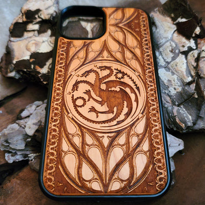 Game of Thrones-inspired wood phone case featuring the Targaryen sigil, laser-engraved with intricate detailing for a unique design. Made from durable wood, this case offers protection and style. Compatible with iPhone , 15, 14, 13, 12, 11, Pro Max, Mini, and Samsung Galaxy S, S24, S23, S22, S21, S20 Ultra, Plus, Note 20. Perfect for fans of Westeros seeking an elegant and protective accessory.