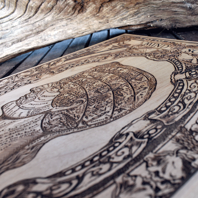 Laser-engraved wood art with vintage symbolical mind illustration.