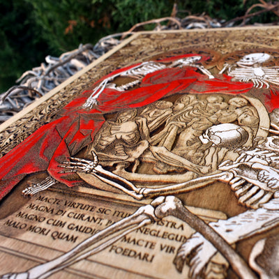 Skeleton couple embracing in death, laser-engraved on deep red wooden plaque.