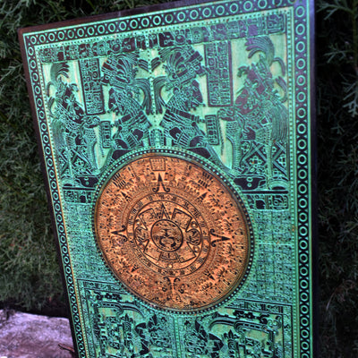 Laser-engraved wooden Aztec sun stone artwork with bold green finish.