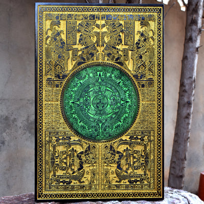 Laser-engraved Aztec calendar on wood, gold and green Mayan sun stone design.