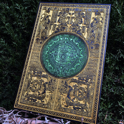 Gold and green Aztec calendar artwork, engraved on wood for wall display.