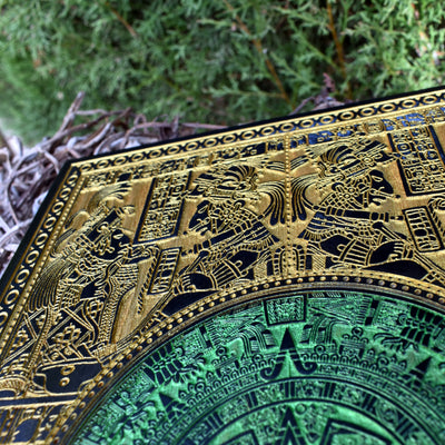 Handmade Aztec sun stone wood decor with metallic green and gold finish.