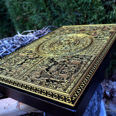 Mesoamerican Aztec calendar design, engraved on rustic wood panel.