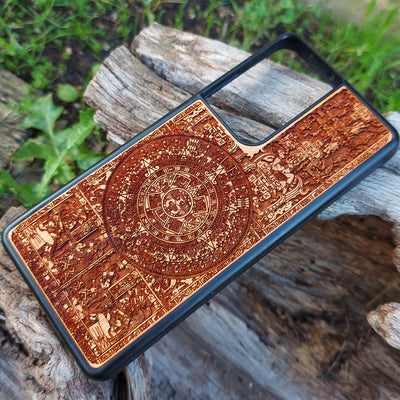 Aztec Calendar wooden phone case featuring detailed engraving, compatible with iPhone & Samsung Galaxy. Eco-friendly and durable design with intricate artwork.