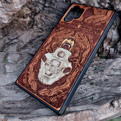 Laser-engraved bear skull design on a wooden phone case, featuring intricate gothic artwork, compatible with iPhone 16, iPhone 15, Galaxy S25, and more.