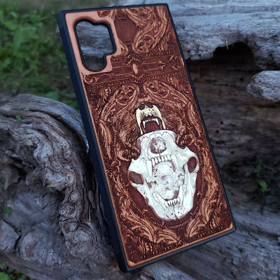 Laser-engraved bear skull design on a wooden phone case, featuring intricate gothic artwork, compatible with iPhone 16, iPhone 15, Galaxy S25, and more.