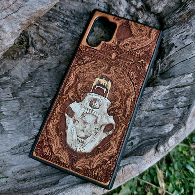 Laser-engraved bear skull design on a wooden phone case, featuring intricate gothic artwork, compatible with iPhone 16, iPhone 15, Galaxy S25, and more.