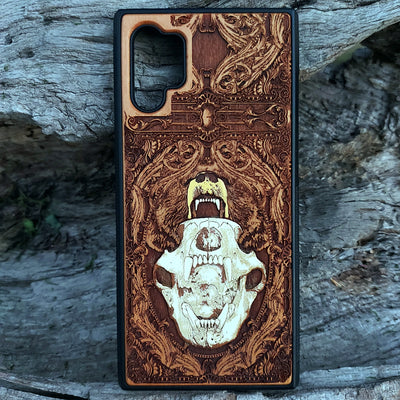 Laser-engraved bear skull design on a wooden phone case, featuring intricate gothic artwork, compatible with iPhone 16, iPhone 15, Galaxy S25, and more.
