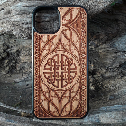 Wood phone case featuring a laser-engraved Celtic knot design surrounded by intricate Elvish-inspired patterns. Crafted for durability and elegance, this case is compatible with iPhone 16, 15, 14, 13, 12, 11, Pro Max, Mini, and Samsung Galaxy S25, S24, S23, S22, S21, S20 Ultra, Plus, Note 20. A stylish and protective accessory for fans of Celtic and Norse art.