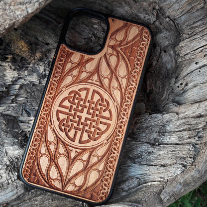 Wood phone case featuring a laser-engraved Celtic knot design surrounded by intricate Elvish-inspired patterns. Crafted for durability and elegance, this case is compatible with iPhone 16, 15, 14, 13, 12, 11, Pro Max, Mini, and Samsung Galaxy S25, S24, S23, S22, S21, S20 Ultra, Plus, Note 20. A stylish and protective accessory for fans of Celtic and Norse art.