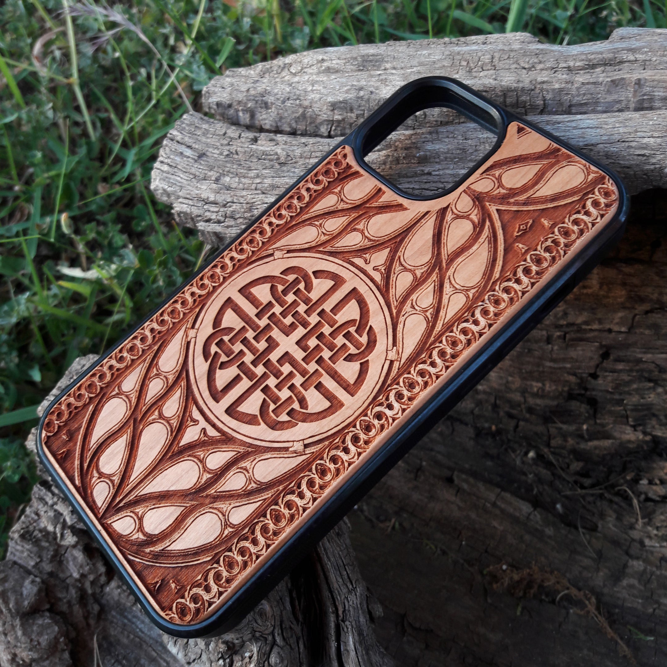 Wood phone case featuring a laser-engraved Celtic knot design surrounded by intricate Elvish-inspired patterns. Crafted for durability and elegance, this case is compatible with iPhone 16, 15, 14, 13, 12, 11, Pro Max, Mini, and Samsung Galaxy S25, S24, S23, S22, S21, S20 Ultra, Plus, Note 20. A stylish and protective accessory for fans of Celtic and Norse art.