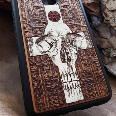 Laser-engraved wooden phone case featuring a gothic skull and cross design, compatible with iPhone 16, iPhone 15, Galaxy S25, and more