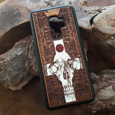Laser-engraved wooden phone case featuring a gothic skull and cross design, compatible with iPhone 16, iPhone 15, Galaxy S25, and more