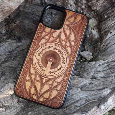 Wooden phone case featuring a Gothic Lord of the Rings-inspired design, with intricate laser-engraved patterns. The design includes dark, medieval-style elements with Elvish script, capturing the essence of Middle-Earth's dark aesthetic. Compatible with iPhone , 15, 14, 13, 12, 11 Pro Max Mini, and Samsung Galaxy S, S24, S23, S22, S21, S20 Ultra, Plus, and Note 20. A unique and protective accessory for Tolkien fans with a taste for Gothic style.