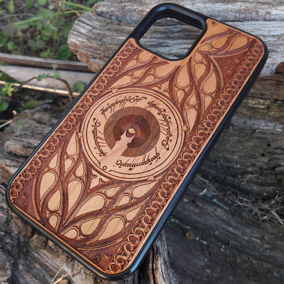 Wooden phone case featuring a Gothic Lord of the Rings-inspired design, with intricate laser-engraved patterns. The design includes dark, medieval-style elements with Elvish script, capturing the essence of Middle-Earth's dark aesthetic. Compatible with iPhone , 15, 14, 13, 12, 11 Pro Max Mini, and Samsung Galaxy S, S24, S23, S22, S21, S20 Ultra, Plus, and Note 20. A unique and protective accessory for Tolkien fans with a taste for Gothic style.