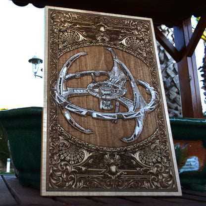 Enterprise-style sci-fi starship design engraved and painted on wood.