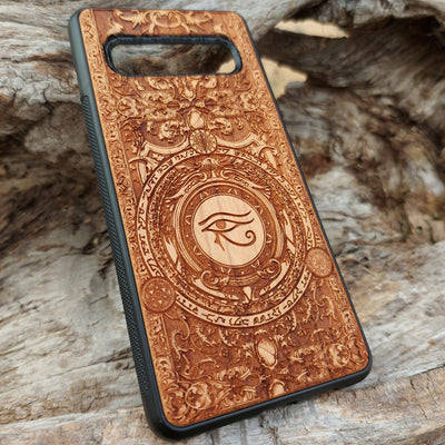 Handcrafted wooden phone case featuring the Eye of Ra symbol intricately engraved with ancient Egyptian-inspired detailing. Designed for iPhone , 15, 14, 13, 12, 11, Pro Max, Mini, and Samsung Galaxy S, S24, S23, S22, S21, S20 Ultra, Plus, Note 20 models. A unique fusion of art and protection for those who admire Egyptian mythology and premium craftsmanship.