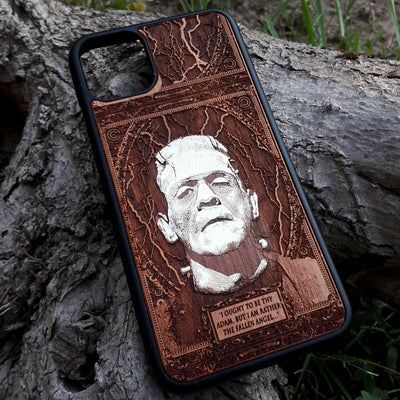 Laser-engraved Frankenstein's monster design on a wooden phone case, featuring the quote “I ought to be thy Adam, but I am rather the fallen angel...” Compatible with iPhone 16 and Samsung Galaxy S25.