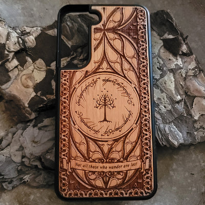 Lord of the Rings wood phone case featuring the White Tree of Gondor, Elvish script, and the iconic quote 'Not all those who wander are lost.' Laser-engraved with intricate detailing, this durable and elegant case is compatible with iPhone , 15, 14, 13, 12, 11, Pro Max, Mini, and Samsung Galaxy S, S24, S23, S22, S21, S20 Ultra, Plus, Note 20. A unique protective accessory for Tolkien fans.