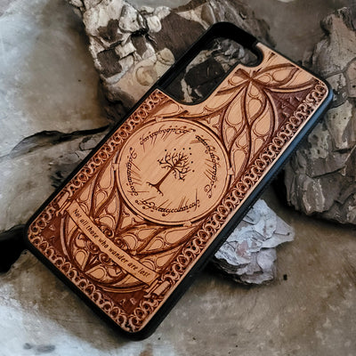 Lord of the Rings wood phone case featuring the White Tree of Gondor, Elvish script, and the iconic quote 'Not all those who wander are lost.' Laser-engraved with intricate detailing, this durable and elegant case is compatible with iPhone , 15, 14, 13, 12, 11, Pro Max, Mini, and Samsung Galaxy S, S24, S23, S22, S21, S20 Ultra, Plus, Note 20. A unique protective accessory for Tolkien fans.
