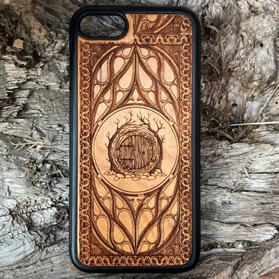 Lord of the Rings Hobbit Door wood phone case, laser-engraved with intricate detailing and decorative patterns. Crafted for durability and elegance, this case is compatible with iPhone , 15, 14, 13, 12, 11, Pro Max, Mini, and Samsung Galaxy S, S24, S23, S22, S21, S20 Ultra, Plus, Note 20. A perfect accessory for Tolkien fans seeking a unique and protective phone case.