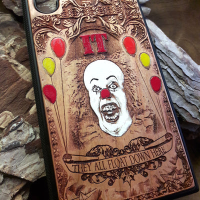 Laser-engraved horror-themed wooden phone case featuring a detailed skull design