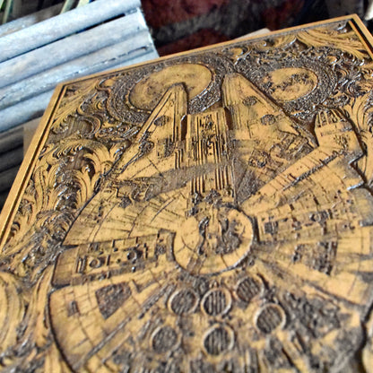 Geeky home decor featuring an intricately engraved Millennium Falcon wood panel