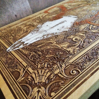 Laser-engraved deer skull wood plaque, perfect for cabin or lodge.