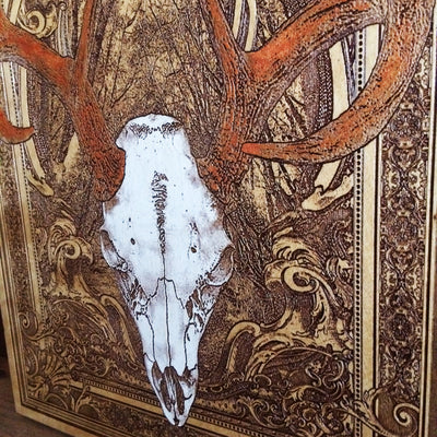 Western-themed deer skull wood decor for rustic and gothic interiors.